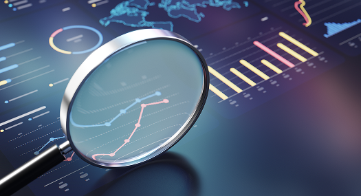 Magnifying glass analyzing market performance charts